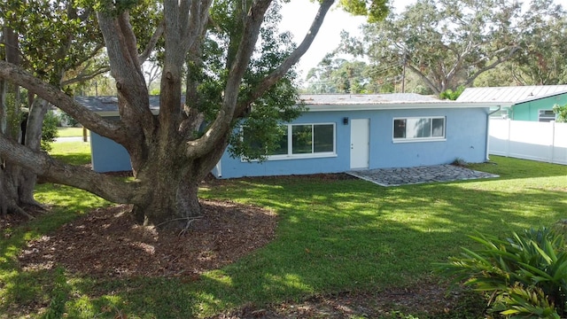 rear view of house featuring a lawn