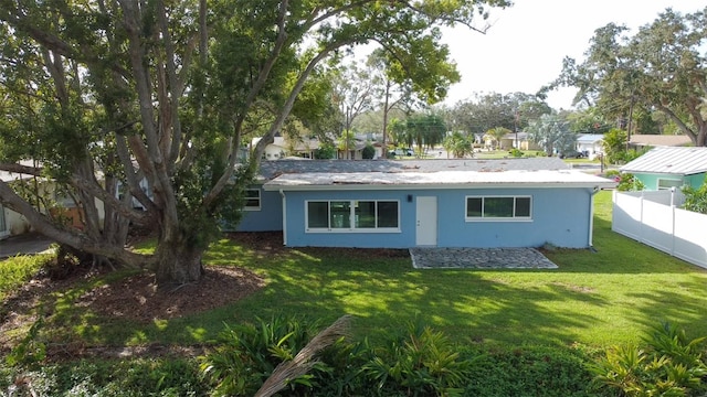 back of house with a lawn