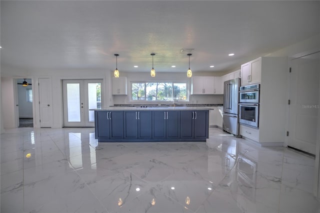 1042 Idlewild Dr N, Dunedin, FL 34698 - kitchen featuring white cabinetry, appliances with stainless steel finishes, blue cabinetry, recessed lighting, and light marble finish floors