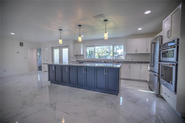 kitchen with white cabinets, decorative light fixtures, stainless steel appliances, and french doors