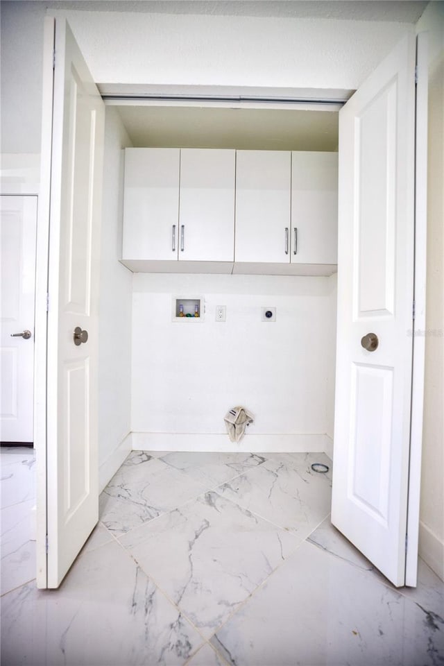 1042 Idlewild Dr N, Dunedin, FL 34698 - laundry room featuring cabinet space, hookup for an electric dryer, light marble finish flooring, washer hookup, and baseboards