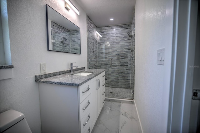 bathroom featuring vanity, toilet, and a shower with shower door