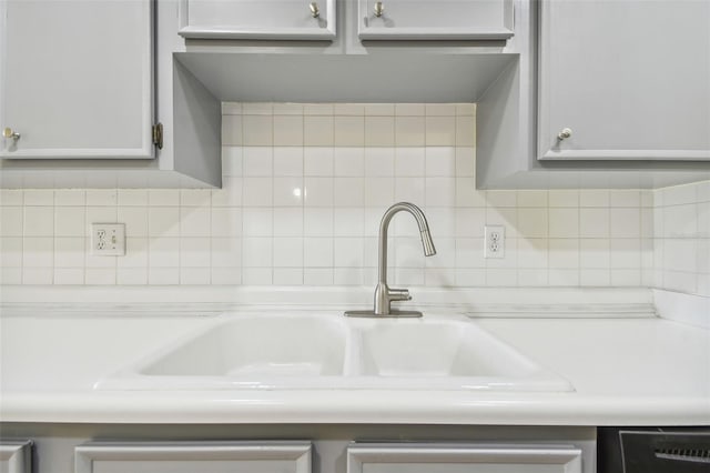 8198 Terrace Garden Dr N Unit 403, Saint Petersburg, FL 33709 - kitchen view of tasteful backsplash, black dishwasher, light countertops, and a sink