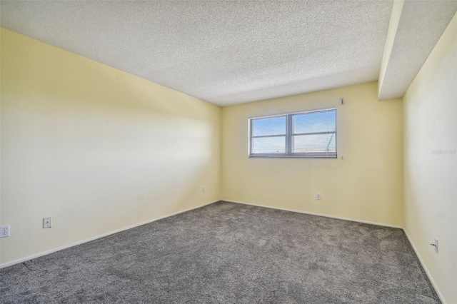 carpeted spare room featuring a textured ceiling