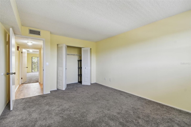 8198 Terrace Garden Dr N Unit 403, Saint Petersburg, FL 33709 - unfurnished bedroom with carpet, a textured ceiling, a closet, and baseboards