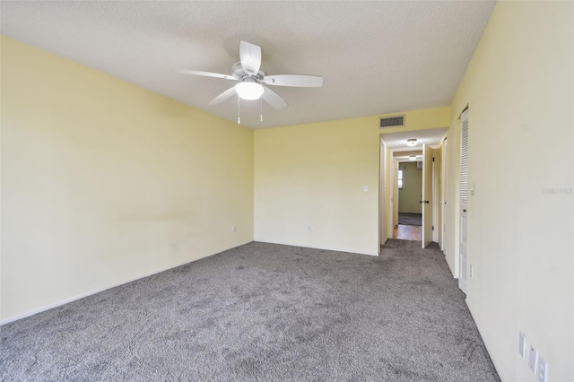 unfurnished room featuring carpet, a textured ceiling, and ceiling fan