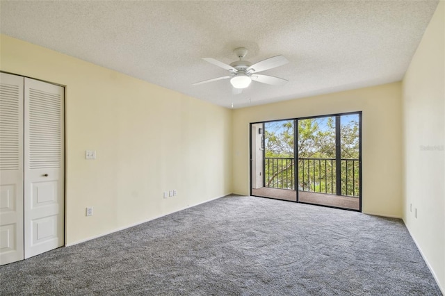 empty room featuring ceiling fan, carpet, and a textured ceiling