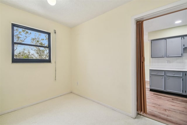 8198 Terrace Garden Dr N Unit 403, Saint Petersburg, FL 33709 - spare room featuring baseboards and a textured ceiling