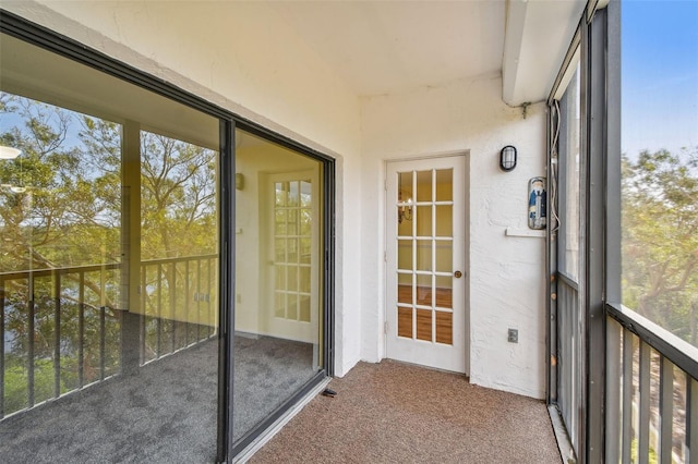 unfurnished sunroom with beamed ceiling