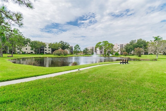 exterior space featuring a lawn and a water view