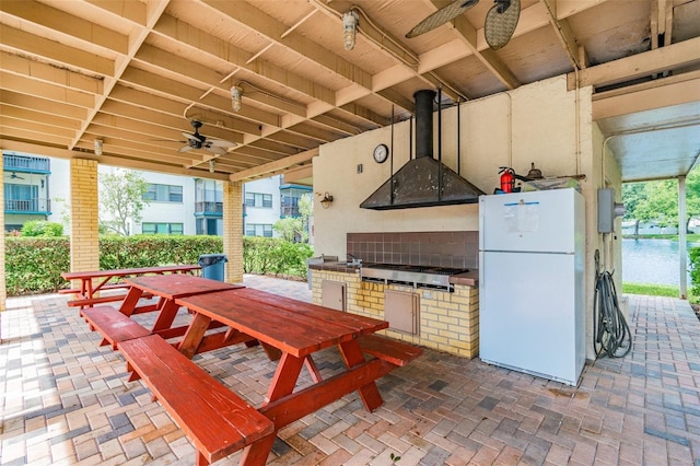 view of patio with ceiling fan and an outdoor kitchen