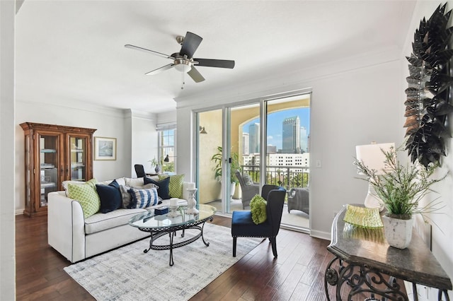 345 Bayshore Blvd Unit 808, Tampa, FL 33606 - living area with dark wood-style flooring, a ceiling fan, crown molding, a city view, and baseboards