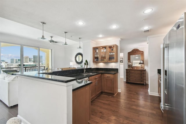 345 Bayshore Blvd Unit 808, Tampa, FL 33606 - kitchen featuring high end fridge, a sink, brown cabinetry, dark wood-style flooring, and glass insert cabinets