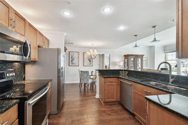 345 Bayshore Blvd Unit 808, Tampa, FL 33606 - kitchen with appliances with stainless steel finishes, a sink, dark wood-type flooring, a chandelier, and brown cabinetry