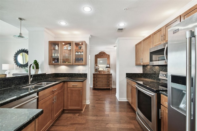345 Bayshore Blvd Unit 808, Tampa, FL 33606 - kitchen featuring appliances with stainless steel finishes, a sink, brown cabinetry, dark wood finished floors, and glass insert cabinets