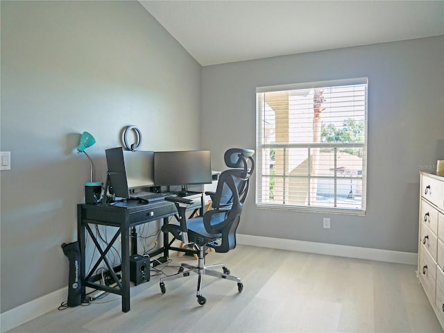 office space with light wood-type flooring and vaulted ceiling