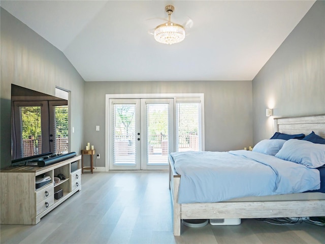 bedroom with french doors, access to outside, light hardwood / wood-style flooring, and multiple windows