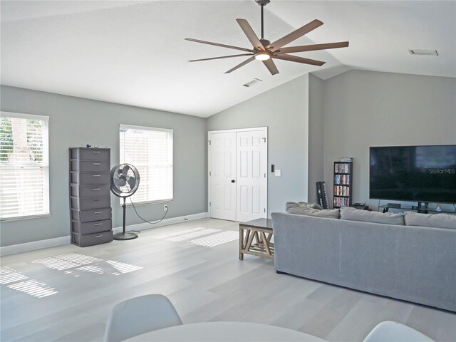 living room with ceiling fan, light hardwood / wood-style floors, and lofted ceiling