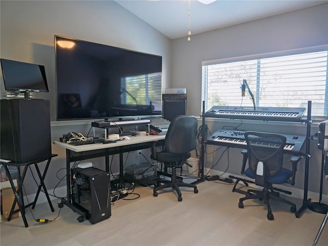 office featuring vaulted ceiling and light hardwood / wood-style flooring