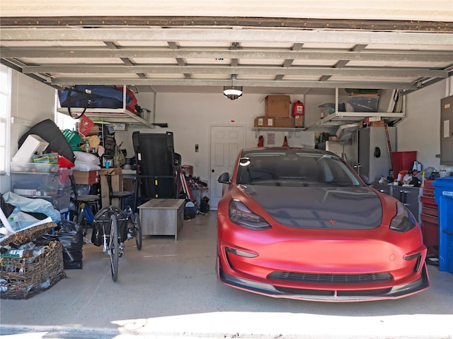 garage with electric panel and a garage door opener