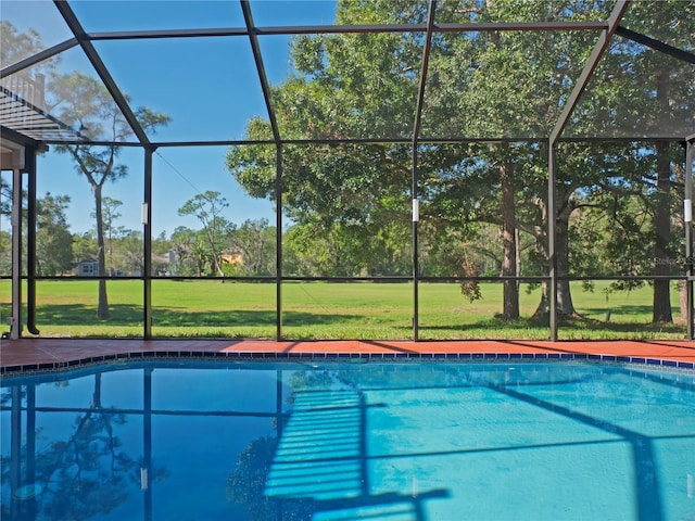 view of swimming pool featuring a lawn and glass enclosure