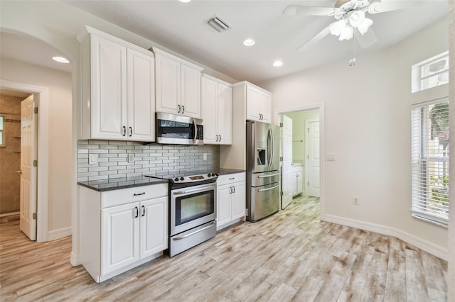 kitchen featuring white cabinets, appliances with stainless steel finishes, light hardwood / wood-style flooring, and ceiling fan