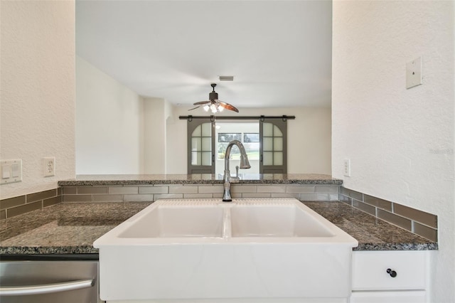 kitchen featuring dishwasher, ceiling fan, kitchen peninsula, and sink