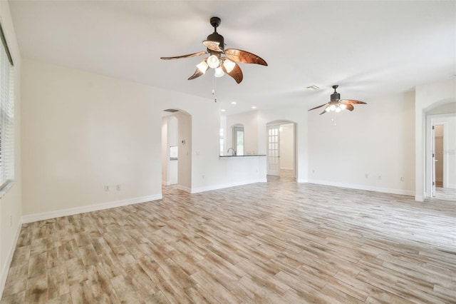 unfurnished living room featuring ceiling fan and light hardwood / wood-style flooring