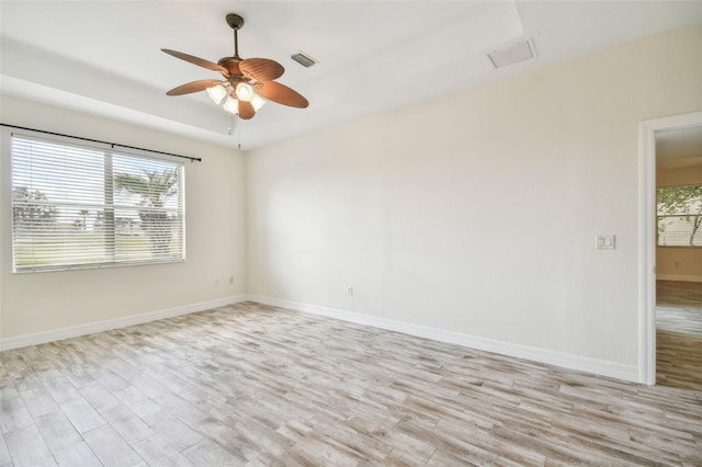 empty room featuring ceiling fan and light hardwood / wood-style floors