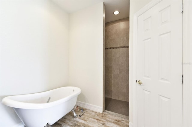 bathroom with plus walk in shower and wood-type flooring