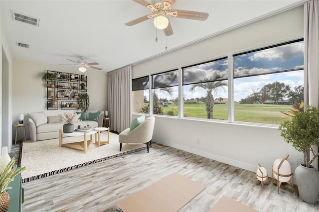 sunroom / solarium featuring ceiling fan