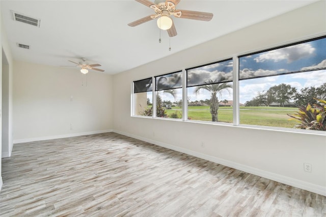 unfurnished sunroom with ceiling fan