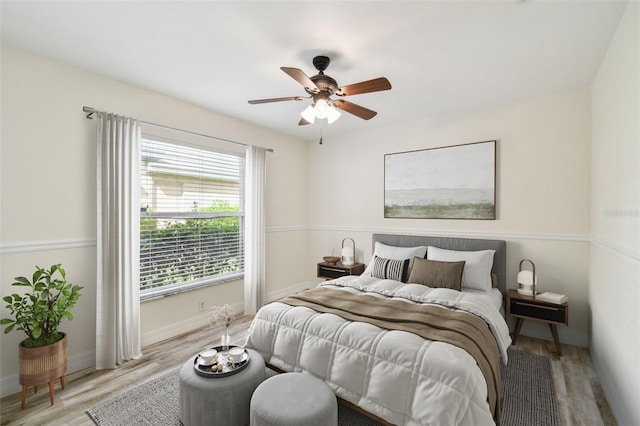 bedroom with light hardwood / wood-style floors and ceiling fan