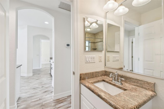 bathroom with hardwood / wood-style flooring and vanity