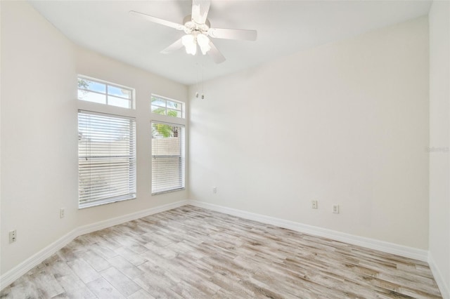 empty room featuring ceiling fan and light hardwood / wood-style floors