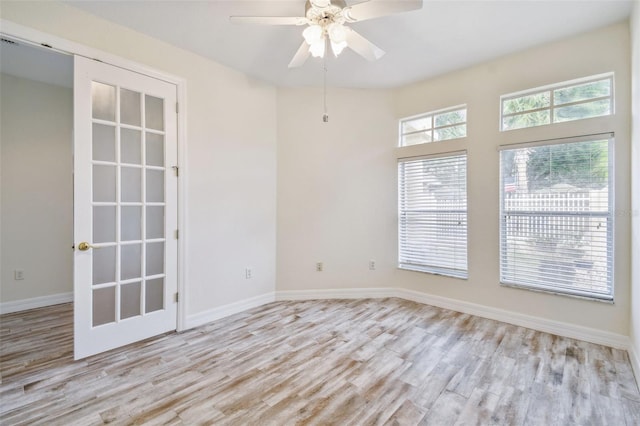 unfurnished room with ceiling fan and light wood-type flooring