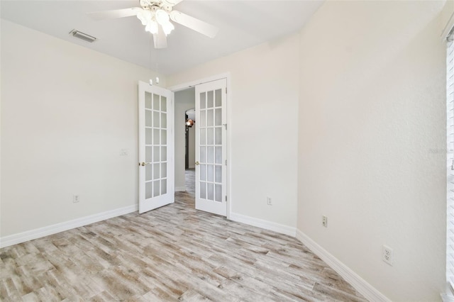 spare room with french doors, light hardwood / wood-style floors, and ceiling fan