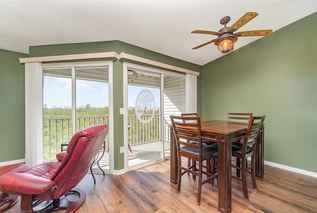 dining space with hardwood / wood-style flooring and ceiling fan