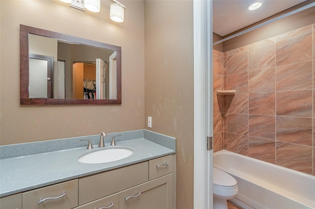 full bathroom with vanity, toilet, and tiled shower / bath