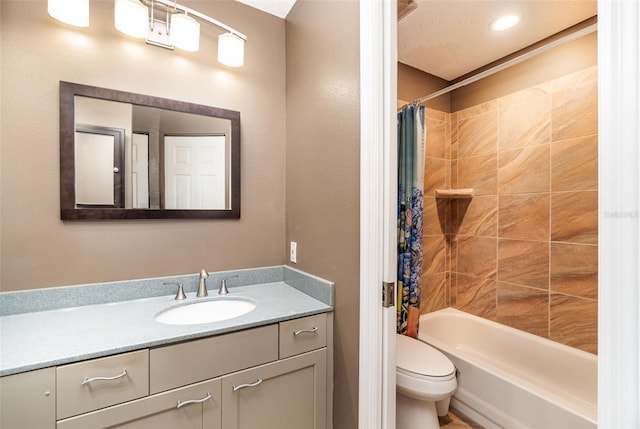 full bathroom with vanity, toilet, and shower / tub combo