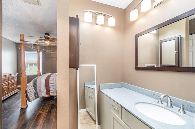 bathroom featuring ceiling fan, a textured ceiling, and vanity