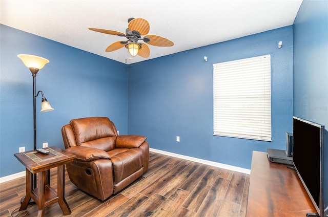 sitting room with ceiling fan and dark hardwood / wood-style flooring