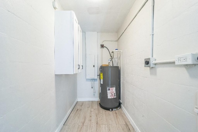 utility room featuring water heater and electric panel