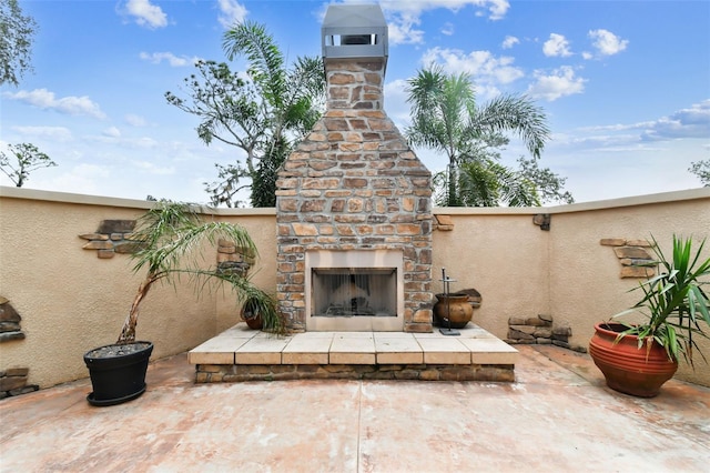 view of patio / terrace featuring an outdoor stone fireplace