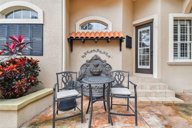 exterior space with a tile roof, a patio, and stucco siding