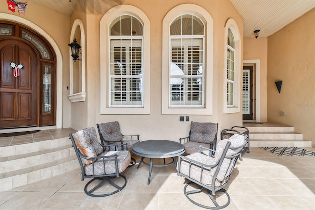 entrance to property with stucco siding