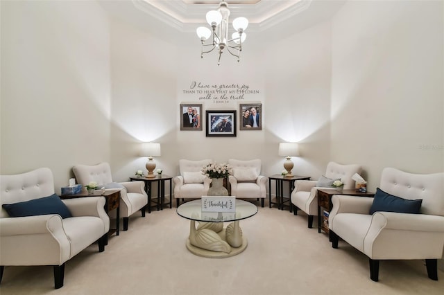 living room featuring light colored carpet, a towering ceiling, an inviting chandelier, a raised ceiling, and crown molding