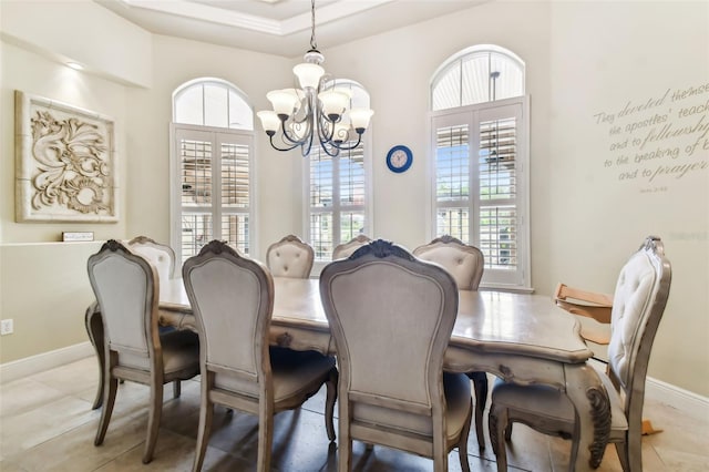 12709 Mannhurst Oak Ln, Lithia, FL 33547 - dining room with a chandelier, baseboards, a raised ceiling, and a high ceiling