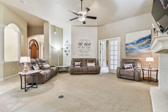 12709 Mannhurst Oak Ln, Lithia, FL 33547 - carpeted living area featuring ornate columns, ceiling fan, arched walkways, and french doors
