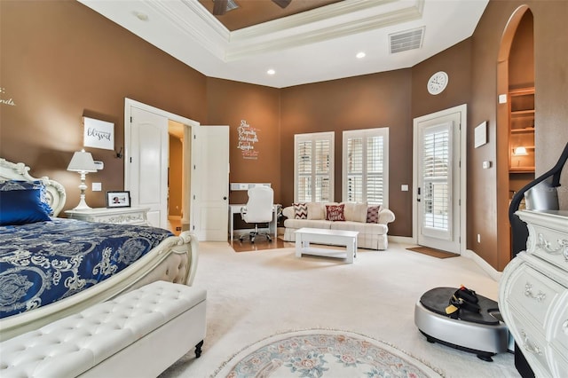 bedroom featuring a raised ceiling, light colored carpet, ornamental molding, and access to outside